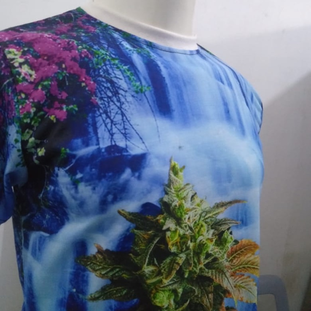 Cannabis bud and Hawaiian waterfall background